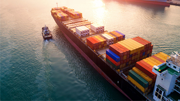 Ocean freighter being guided into port
