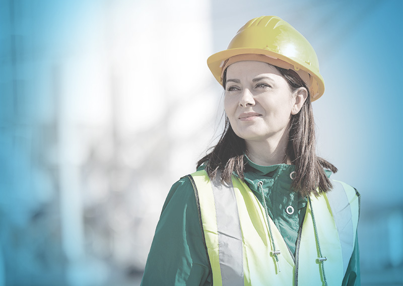 Woman in a hard hat depicting importance of robust project management capabilities.