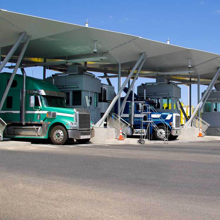 Semi-trucks in a border crossing checkpoint vestibule